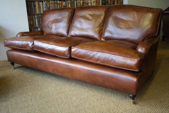 The Loose Back Cushion Three-Seater Lansdown Sofa in Leather with Turned Legs & Castors